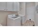 Well-equipped laundry room with washer, dryer, and plenty of cabinet space at 300 Williamston Ridge Dr, Youngsville, NC 27596