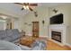 Inviting living room with fireplace, TV, vaulted ceilings, and hardwood floors at 300 Williamston Ridge Dr, Youngsville, NC 27596