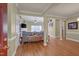 Open-concept living room with hardwood floors, crown molding, and neutral color scheme at 300 Williamston Ridge Dr, Youngsville, NC 27596