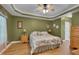 A spacious main bedroom with green walls, ceiling fan and hardwood floors at 300 Williamston Ridge Dr, Youngsville, NC 27596