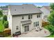 An elevated view of the backyard with patio, furniture, and well-manicured lawn at 304 Forbes Rd, Wake Forest, NC 27587
