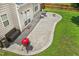 A concrete backyard patio features a fire pit, seating and a BBQ grill at 304 Forbes Rd, Wake Forest, NC 27587