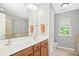 Bright bathroom with a double sink vanity and separate tub and shower at 304 Forbes Rd, Wake Forest, NC 27587