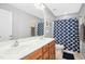 Well-lit bathroom with a double sink vanity and a shower-tub combination at 304 Forbes Rd, Wake Forest, NC 27587