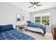 Bright bedroom with two twin beds, ceiling fan, and a sunlit window at 304 Forbes Rd, Wake Forest, NC 27587