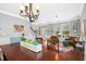 Dining room showcasing hardwood floors, a chandelier, and access to the entryway and living spaces for easy entertaining at 304 Forbes Rd, Wake Forest, NC 27587