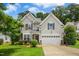 Charming two-story home featuring a well-maintained lawn, attached garage, and neutral siding for a welcoming curb appeal at 304 Forbes Rd, Wake Forest, NC 27587