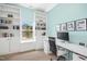 Bright home office featuring custom built-in shelves, a modern desk, and a view of the outdoors at 304 Forbes Rd, Wake Forest, NC 27587