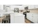 Well-lit kitchen featuring white countertops, stainless steel appliances, and a breakfast bar with room for seating at 304 Forbes Rd, Wake Forest, NC 27587