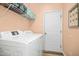 Functional laundry room with a washer, dryer, storage shelves, and plenty of space at 304 Forbes Rd, Wake Forest, NC 27587