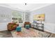 Inviting living room featuring hardwood floors, a colorful rug, comfortable seating, and natural light from the window at 304 Forbes Rd, Wake Forest, NC 27587