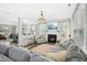 Spacious living room with a fireplace, chandelier, and open access to other rooms at 304 Forbes Rd, Wake Forest, NC 27587