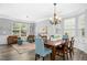 Open-concept living space with hardwood floors, natural light, a chandelier, and views into the adjacent living area at 304 Forbes Rd, Wake Forest, NC 27587