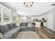 Open concept living space with kitchen, dining area, and living room, hardwood floors and modern design at 304 Forbes Rd, Wake Forest, NC 27587