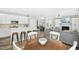 Open floor plan features a living room, dining area, and kitchen with hardwood floors throughout at 304 Forbes Rd, Wake Forest, NC 27587