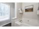 Bathroom showcasing a deep soaking tub, a window for natural light, and decorative elements at 3045 Creek Moss Ave, Wake Forest, NC 27587