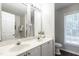 Bathroom featuring a double sink vanity, large mirror, and ample lighting at 3045 Creek Moss Ave, Wake Forest, NC 27587