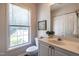 Bright bathroom with a white vanity, toilet, and a large window for natural light at 3045 Creek Moss Ave, Wake Forest, NC 27587