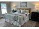 Cozy main bedroom with plush bedding, stylish decor, and plenty of natural light at 3045 Creek Moss Ave, Wake Forest, NC 27587