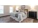 Comfortable bedroom with a queen bed, lamps, and a stylish patterned rug at 3045 Creek Moss Ave, Wake Forest, NC 27587