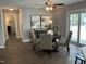 A dining room with a gray accent wall, a ceiling fan, and sliding door access to the outdoor space at 3045 Creek Moss Ave, Wake Forest, NC 27587
