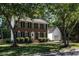 Charming brick two-story home with mature trees and well-manicured lawn at 3045 Creek Moss Ave, Wake Forest, NC 27587