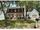 Charming two-story brick home featuring black shutters, a manicured lawn, and mature trees for added curb appeal at 3045 Creek Moss Ave, Wake Forest, NC 27587