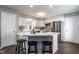 Bright kitchen with white cabinets, stainless steel appliances, and breakfast bar at 3045 Creek Moss Ave, Wake Forest, NC 27587