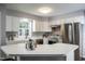 Bright kitchen featuring white cabinets, stainless steel appliances, and a white countertop at 3045 Creek Moss Ave, Wake Forest, NC 27587