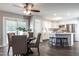 Open kitchen with white cabinets, stainless steel appliances, and eat-in breakfast bar at 3045 Creek Moss Ave, Wake Forest, NC 27587