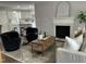 Comfortable living room with fireplace, open to the kitchen, featuring modern decor, and hardwood floors at 3045 Creek Moss Ave, Wake Forest, NC 27587