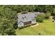 Aerial view of the house featuring well-manicured lawn and mature trees in the surrounding landscape at 3113 Golden Nugget Dr, Clayton, NC 27520