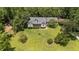 Sprawling property featuring lush greenery, mature trees, and a charming home with a covered porch at 3113 Golden Nugget Dr, Clayton, NC 27520