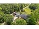 Aerial view showcasing the home's location with mature trees, circular driveway, and lush landscaping at 3113 Golden Nugget Dr, Clayton, NC 27520