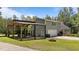Backyard featuring a pergola, fenced area, and mature landscaping, perfect for outdoor enjoyment at 3113 Golden Nugget Dr, Clayton, NC 27520