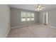 Cozy bedroom with large window, ceiling fan, and neutral carpet at 3113 Golden Nugget Dr, Clayton, NC 27520