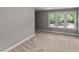 Neutral bedroom features a large window and neutral walls and carpet at 3113 Golden Nugget Dr, Clayton, NC 27520