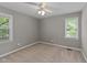 Bedroom with two windows, ceiling fan, and neutral carpeting at 3113 Golden Nugget Dr, Clayton, NC 27520