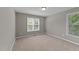 Neutral bedroom with two windows and beige carpet at 3113 Golden Nugget Dr, Clayton, NC 27520