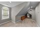 Cozy bonus room featuring an arched window for natural light and custom built-in cabinets at 3113 Golden Nugget Dr, Clayton, NC 27520