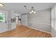 Bright dining area featuring wood floors, trim work and access to the kitchen at 3113 Golden Nugget Dr, Clayton, NC 27520