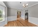 Spacious dining room with hardwood flooring and modern chandelier at 3113 Golden Nugget Dr, Clayton, NC 27520