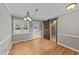 Light-filled dining room featuring hardwood floors, modern chandelier, and rustic sliding barn door at 3113 Golden Nugget Dr, Clayton, NC 27520