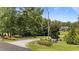 Long gravel driveway leading to the property, surrounded by lush greenery and mature trees at 3113 Golden Nugget Dr, Clayton, NC 27520