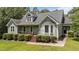This lovely green house features a covered porch, manicured hedges, and a bay window at 3113 Golden Nugget Dr, Clayton, NC 27520