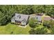 Charming two-story home featuring a bay window, dormers, and lush, mature landscaping at 3113 Golden Nugget Dr, Clayton, NC 27520