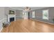 Bright living room with hardwood floors, fireplace, and staircase access at 3113 Golden Nugget Dr, Clayton, NC 27520