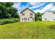 Large backyard with lush green lawn, mature trees, and a two-story home at 3445 Dutchman Rd, Raleigh, NC 27610