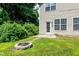 Home's backyard featuring a fire pit, a patio, and lush greenery at 3445 Dutchman Rd, Raleigh, NC 27610