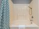 Bathroom showcasing a luxurious soaking tub with a shower head and a tiled surround for a relaxing experience at 3445 Dutchman Rd, Raleigh, NC 27610